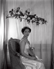 Princess Margaret sitting under a branch of roses